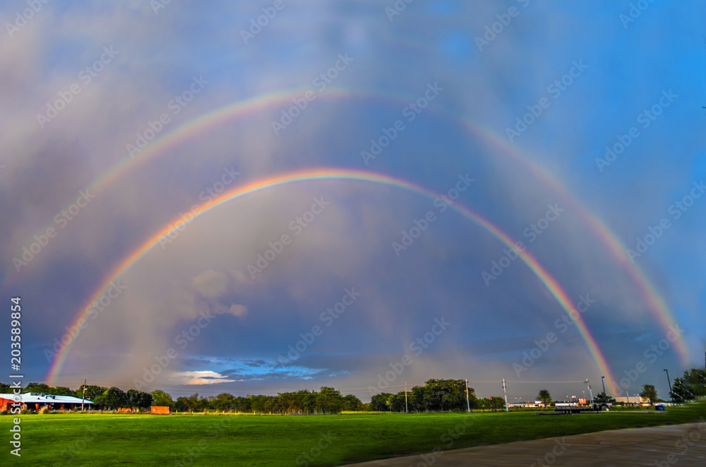 A double rainbow forms briefly, as the sun sets before a storm. A double rainbow forms briefly, as the sun sets before a storm.