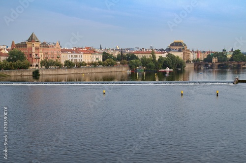 View of the Vltava river in Prague. The building of the National Theater is in the background.