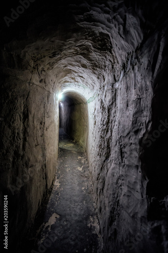 Dark underground passage of old chalky cave monastery 