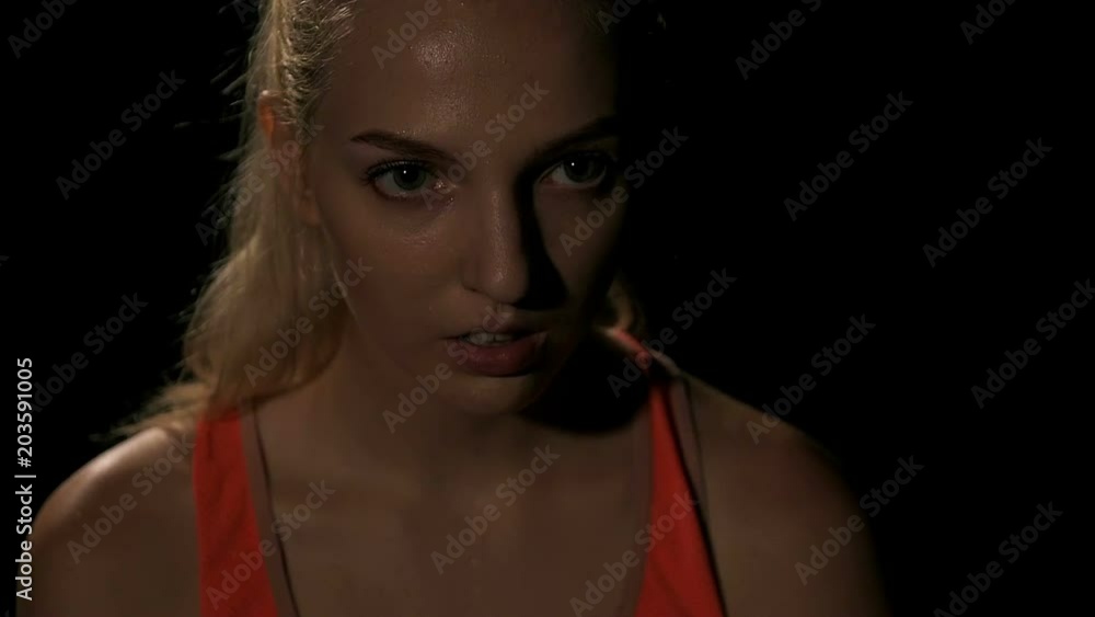 Slow motion of boxer portrait. Young white woman in black background. Fighting sport fitness concept. Slow motion of boxer portrait. Young white woman in black background. Fighting sport fitness concept.