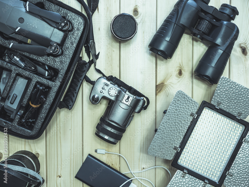 top down overhead view of filmmaking supplies for traveling on a wooden surface top down overhead view of filmmaking supplies for traveling on a wooden surface
