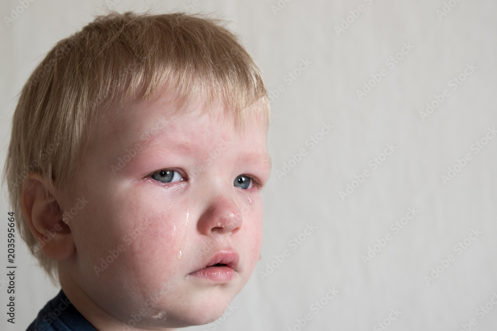 Cry. Portrait of boy. Caucasian child looks at camera. Charming boy the kid cries with tears in his eyes. an angry temper. hysterics. Cry. Portrait of boy. Caucasian child looks at camera. Charming boy the kid cries with tears in his eyes. an angry temper. hysterics.