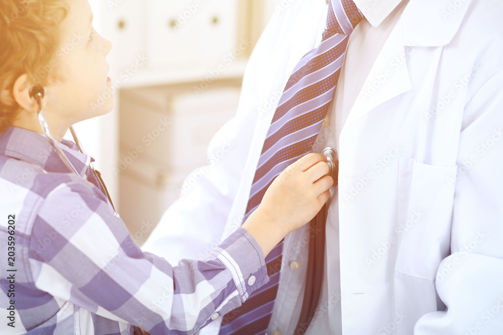 Doctor examining a child patient by stethoscope Doctor examining a child patient by stethoscope