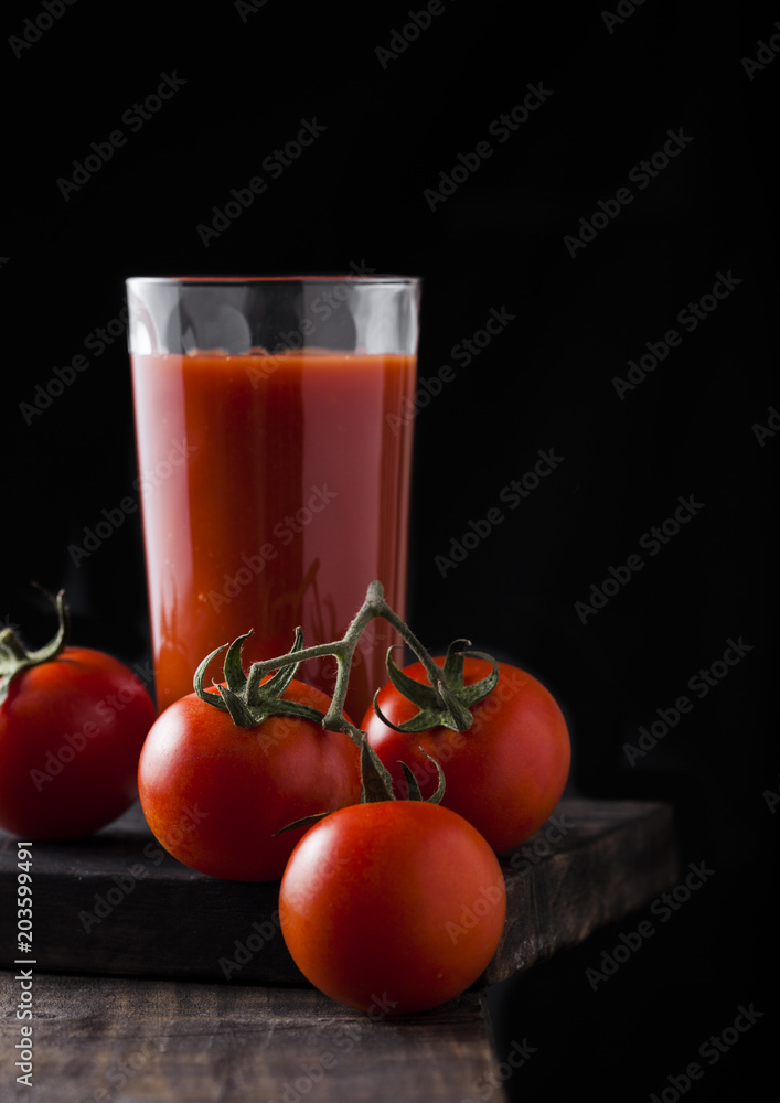 Glass of tomato juice with fresh raw tomatoes Glass of tomato juice with fresh raw tomatoes