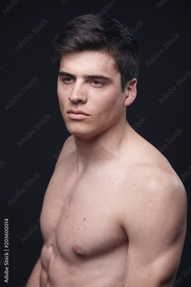 one young handsome man, model shirtless, simple studio upper body shot, black background. one young handsome man, model shirtless, simple studio upper body shot, black background.
