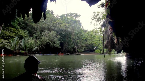 Boat with tourists coming out of Sabang Underground river cave in Palawan, Philippines. Adventure tour concept