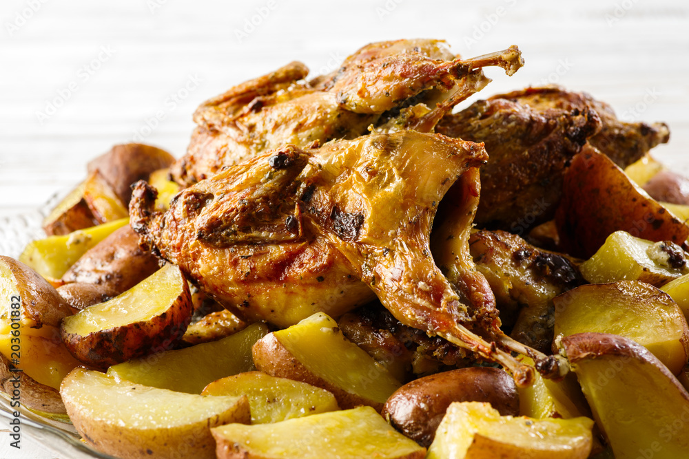 quails with potatoes baked at home on the table