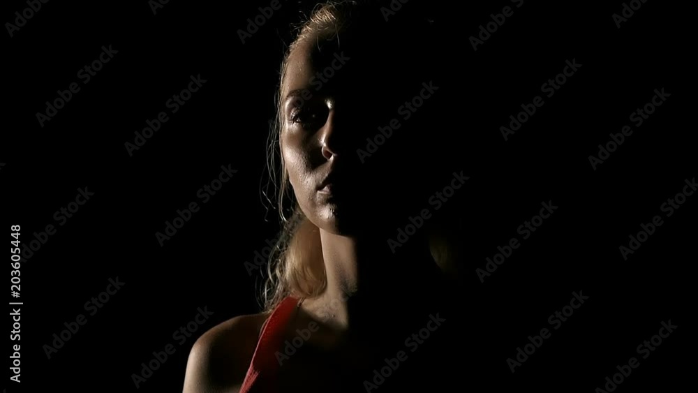 Slow motion of boxer portrait. Young white woman in black background. Fighting sport fitness concept. Slow motion of boxer portrait. Young white woman in black background. Fighting sport fitness concept.
