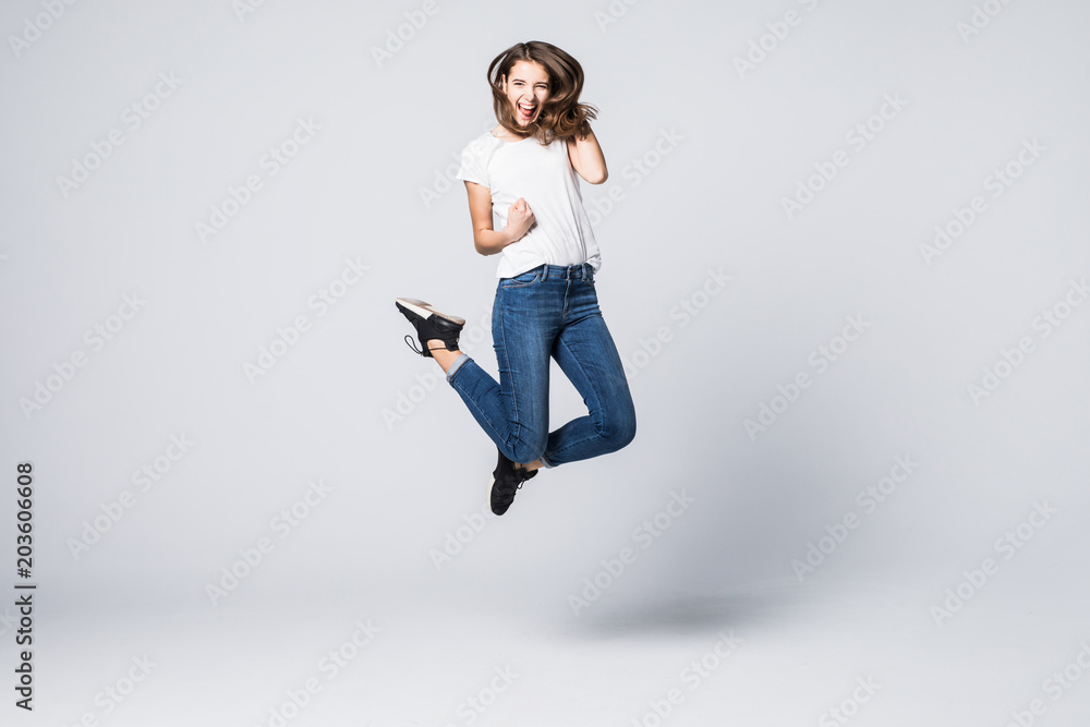 Joy fun enjoy funny crazy mad funky chill positive lifestyle person concept. Full-size view of excited cheerful delight rejoicing pretty woman jumping up isolated on gray background Joy fun enjoy funny crazy mad funky chill positive lifestyle person concept. Full-size view of excited cheerful delight rejoicing pretty woman jumping up isolated on gray background