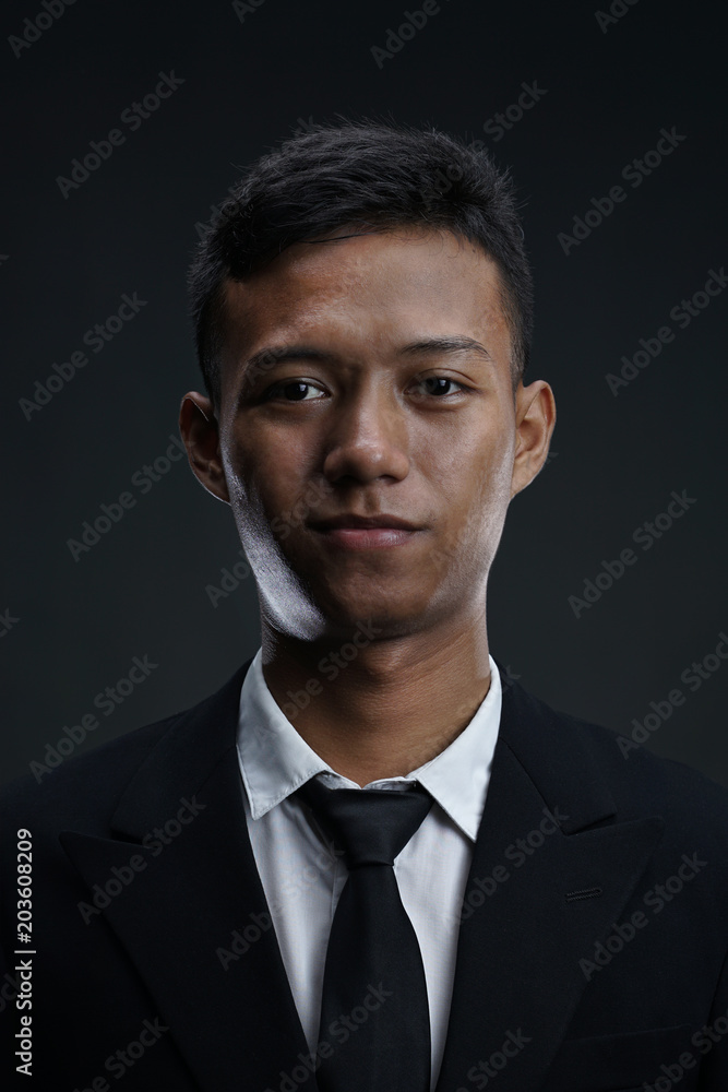 Portrait of Asian Businessman Looking Camera with Dark Background Portrait of Asian Businessman Looking Camera with Dark Background