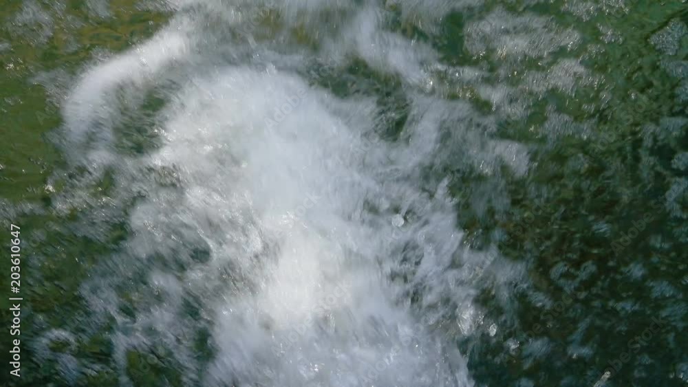 A quick stream of dirty water flows into the pool A quick stream of dirty water flows into the pool