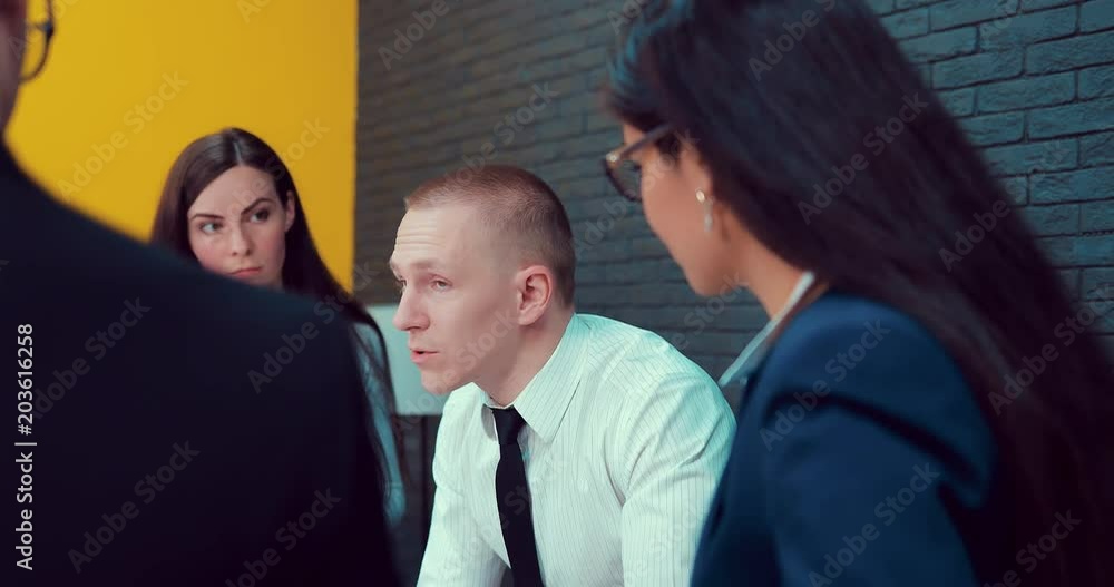 Director discusses business plan with company employees Director discusses business plan with company employees