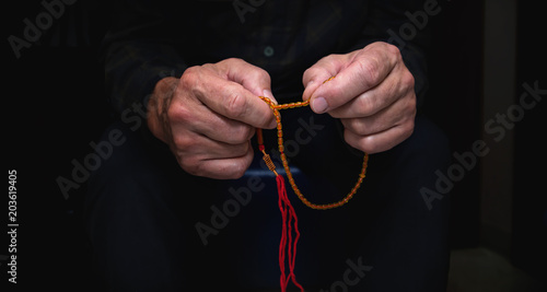 Close view of men's hands with rosary
