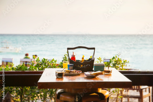 Breakfast set on the table beside the sea beach in the Southern of Thailand