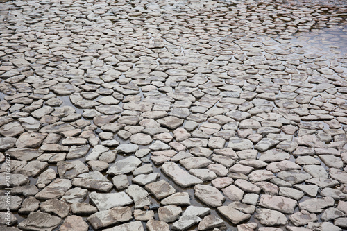 Rock ground patterns near the river. Texture for background