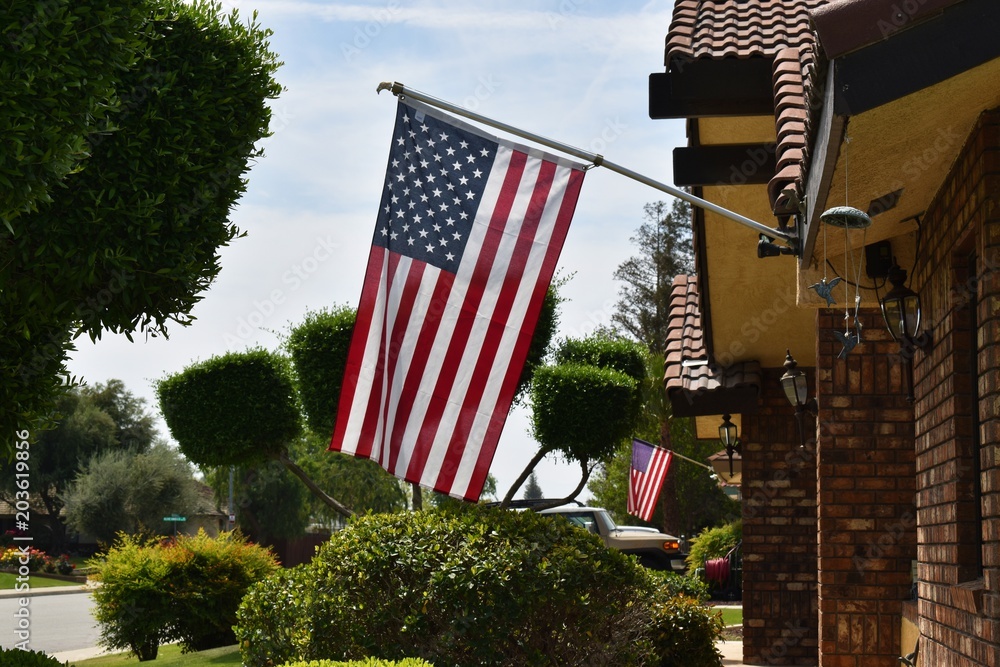 American flags hanging on patriotic houses