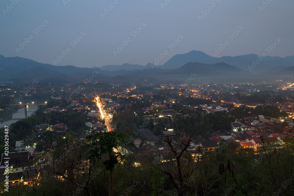 The city of Luang Prabang in Laos viewed from above from the Mount Phousi (Phou Si, Phusi, Phu Si) at dusk.