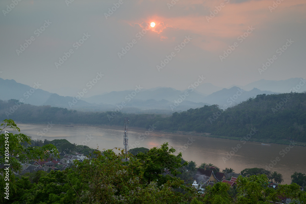 The city of Luang Prabang, Mekong River and beyond viewed from above from the Mount Phousi (Phou Si, Phusi, Phu Si) in Laos at sunset.