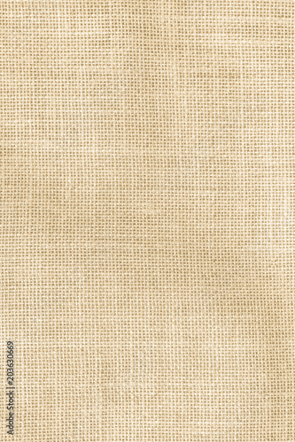 Hessian sackcloth woven texture pattern background in light cream yellow beige earth tone color