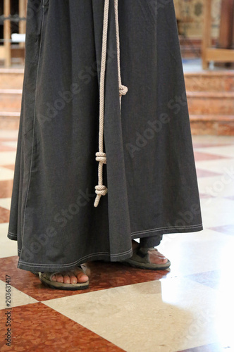 Fototapeta barefoot friar with sandals and brown habit in the cathedral