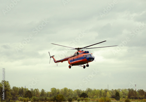 red helicopter takes off