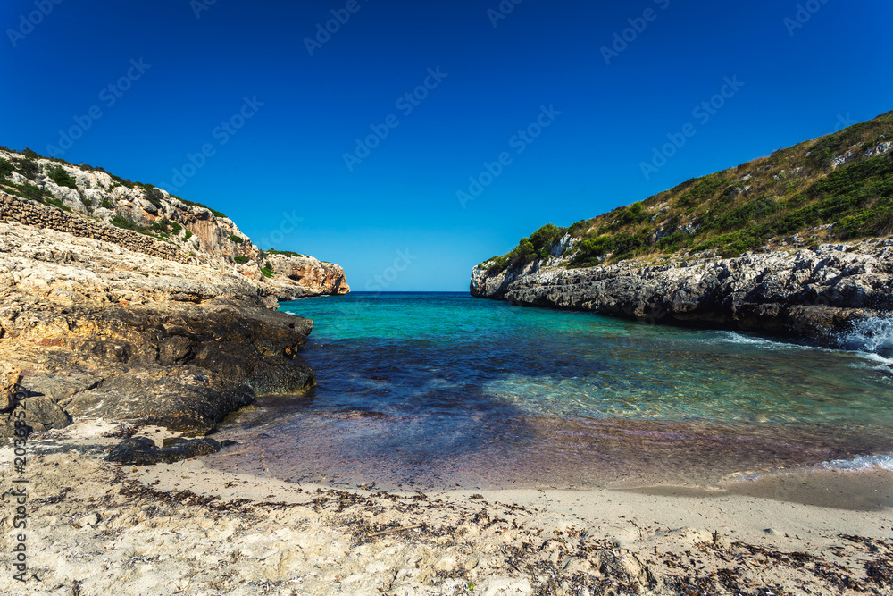 Beautiful hidden sandy beach with turquoise water in Mallorca, Spain