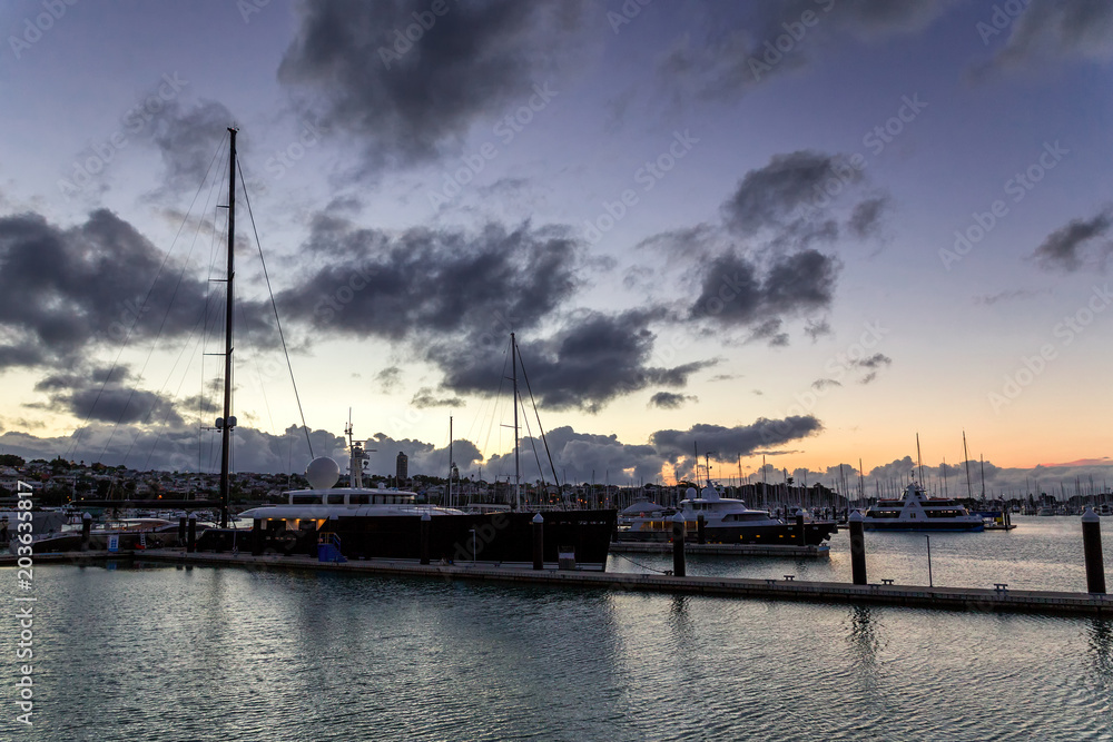 Luxurious yachts at sunset in Auckland's harbour, New Zealand