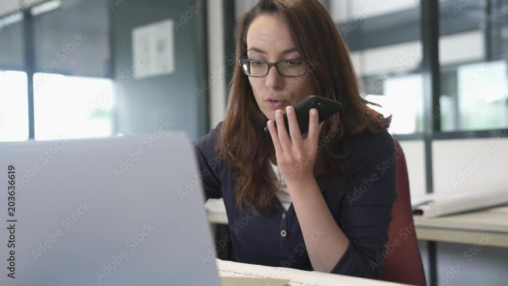 Businesswoman in office talking on phone Businesswoman in office talking on phone