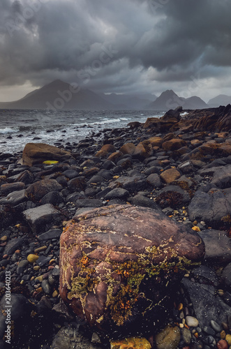 Dramatic landscape coastline view of rocks and Cullin hills, Scotland photo