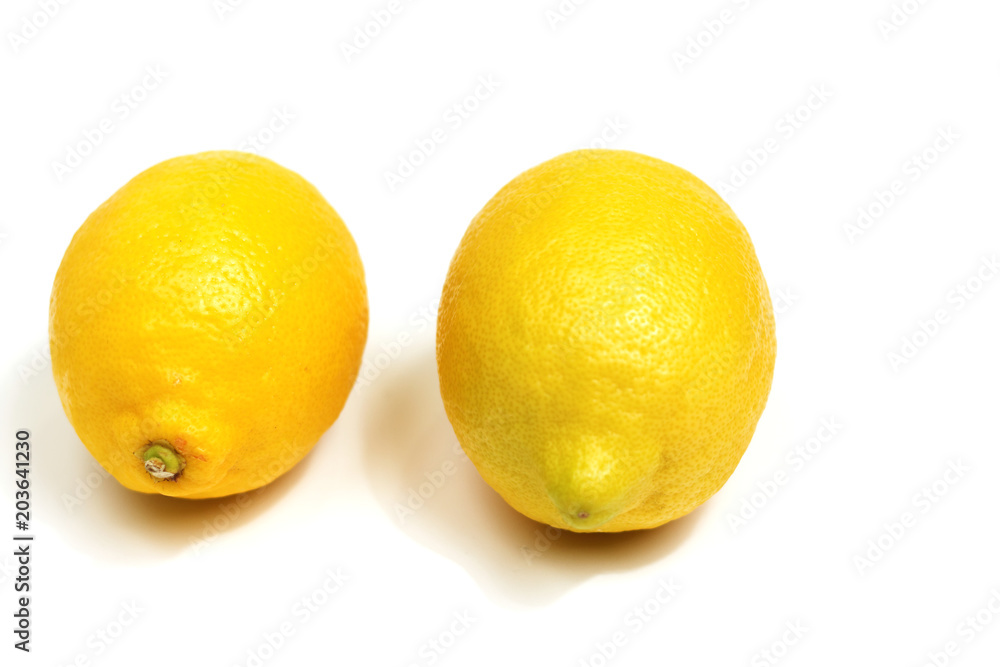 Two yellow lemons isolated on white background