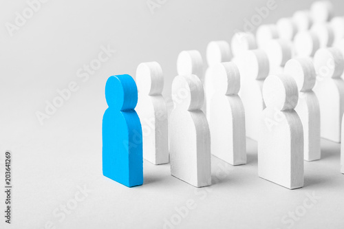 Concept leader of the business team indicates the direction of the movement towards the goal. Crowd of white men goes for the leader of the blue color