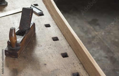 carpenter hand plane on wooden background.copy space