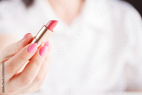 Female handle a lipstick on hand