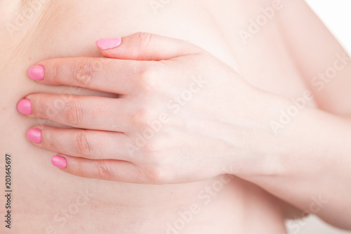 health, medicine and beauty concept - woman checking breast for signs of cancer