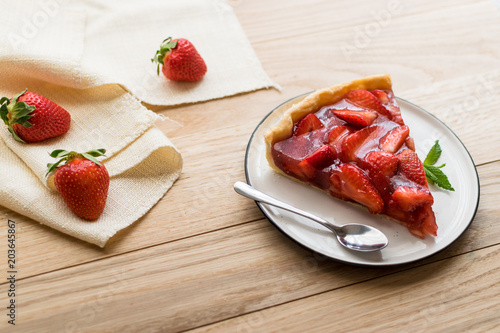 strawberry tart on wooden background.