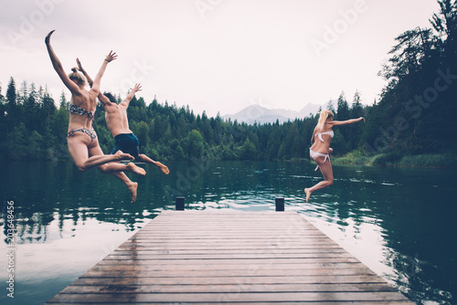Group of friends having fun at the lake in the morning