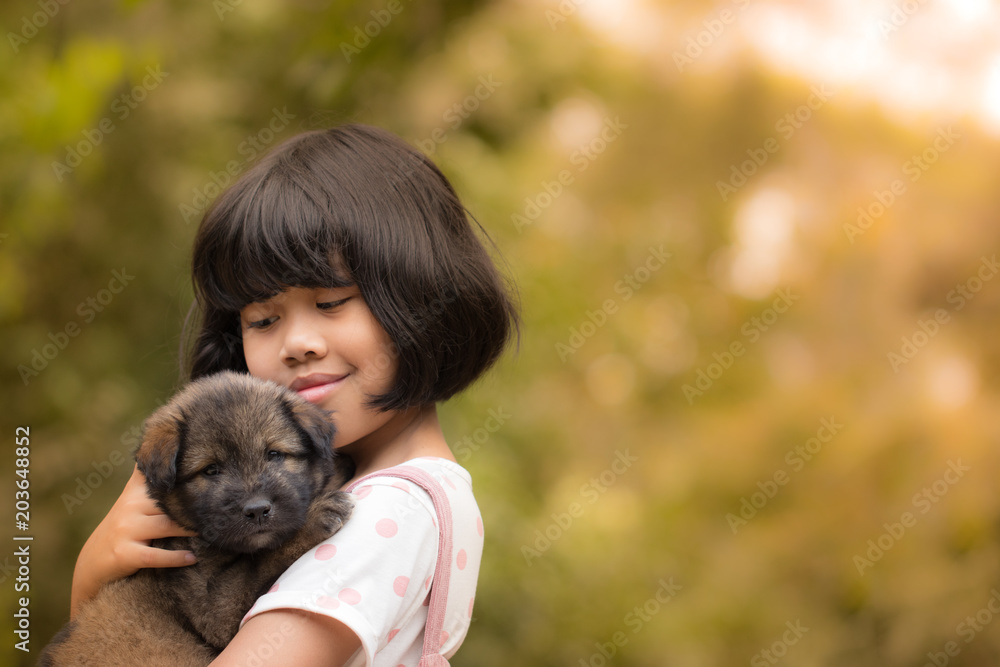 Pretty child girl hug the dog on blur green background Pretty child girl hug the dog on blur green background