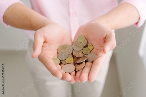 Coins in male hands. Saving money concept.
