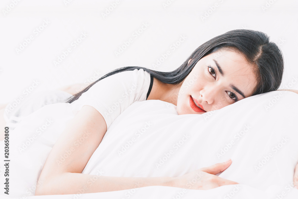 Beautiful woman relaxing on the bed in her room at home Beautiful woman relaxing on the bed in her room at home