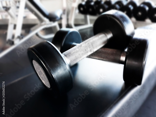 Dumbbells for fitness in the gym lie on a rubberized bench