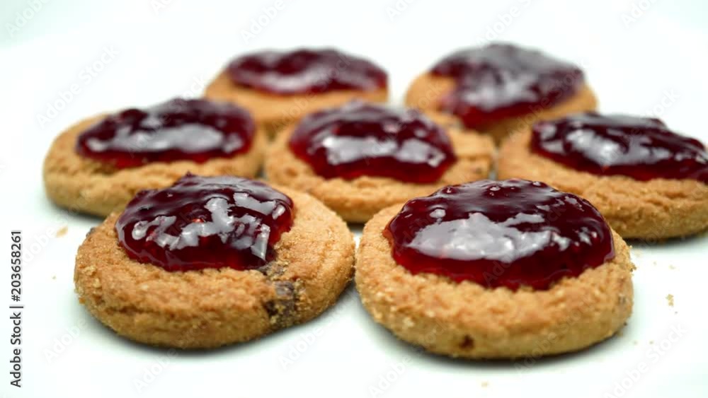 Raspberry jam on cookies. On a rotating white background. 4K Raspberry jam on cookies. On a rotating white background. 4K