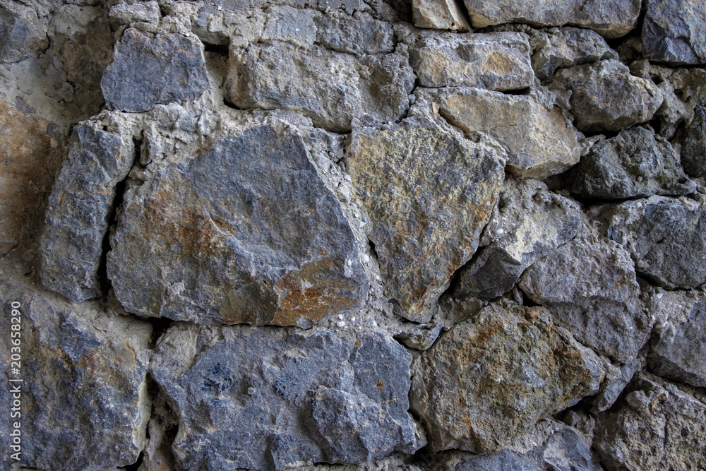 Old stone wall rustic texture background. Blue and gray retro stone wall background. Brick rock texture Old stone wall rustic texture background. Blue and gray retro stone wall background. Brick rock texture