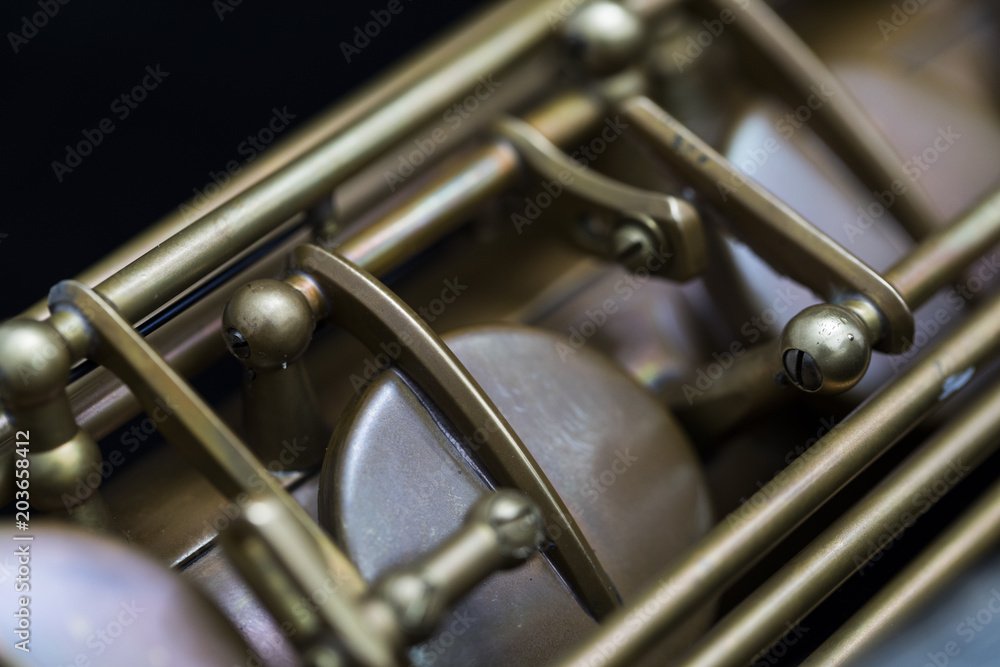Fototapeta premium Vintage saxophone on a black background