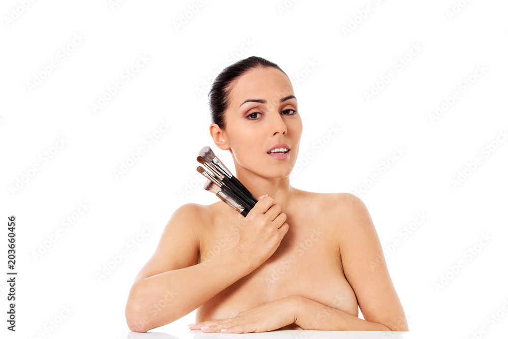Beautiful face of young woman with make up brush. Beautiful face of young woman with make up brush.
