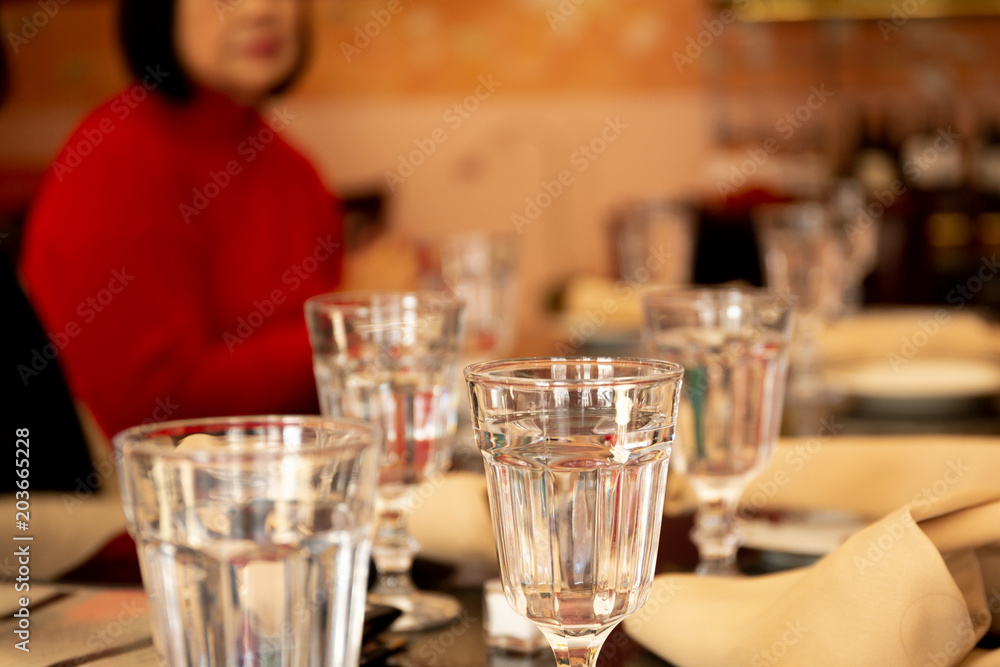Selected focus glass of water on dinner table