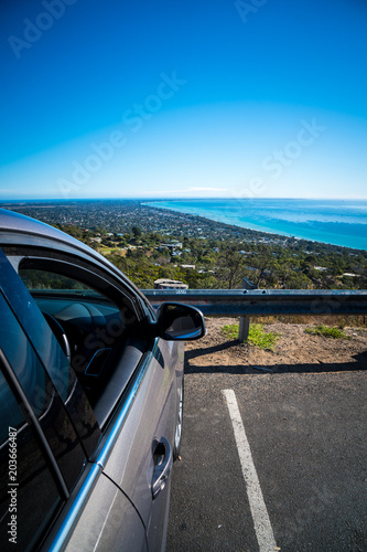 Car parking on mountain looking over to ocean