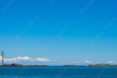 horizon over water with small island copy space in northern ireland 