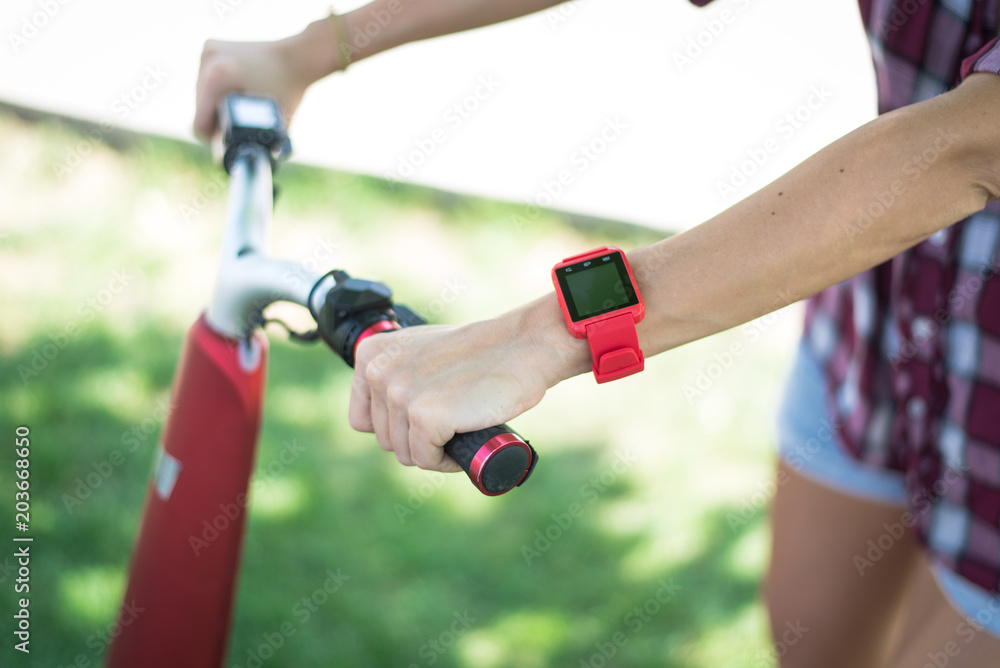 BUCHAREST, ROMANIA, - October 26, 2017: Person using smart watch and a smartphone walking on the park in a sunday. Woman making gestures on a wearable smart watch. Illustrative editorial content. BUCHAREST, ROMANIA, - October 26, 2017: Person using smart watch and a smartphone walking on the park in a sunday. Woman making gestures on a wearable smart watch. Illustrative editorial content.