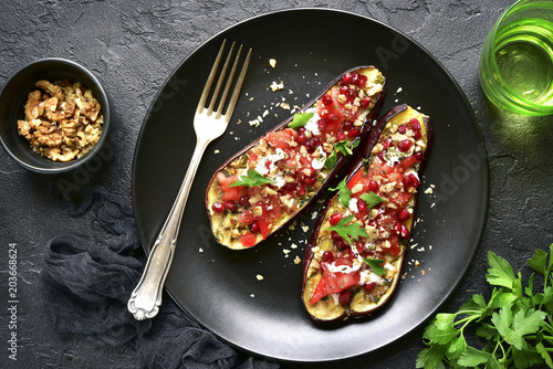 Grilled eggplant stuffed with tomatoes, nuts, pomegranate and yogurt dressing.Top view.