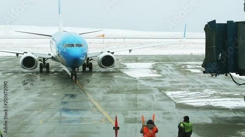 Aircraft Marshaller Directing Plane in the Airport Runway. photo